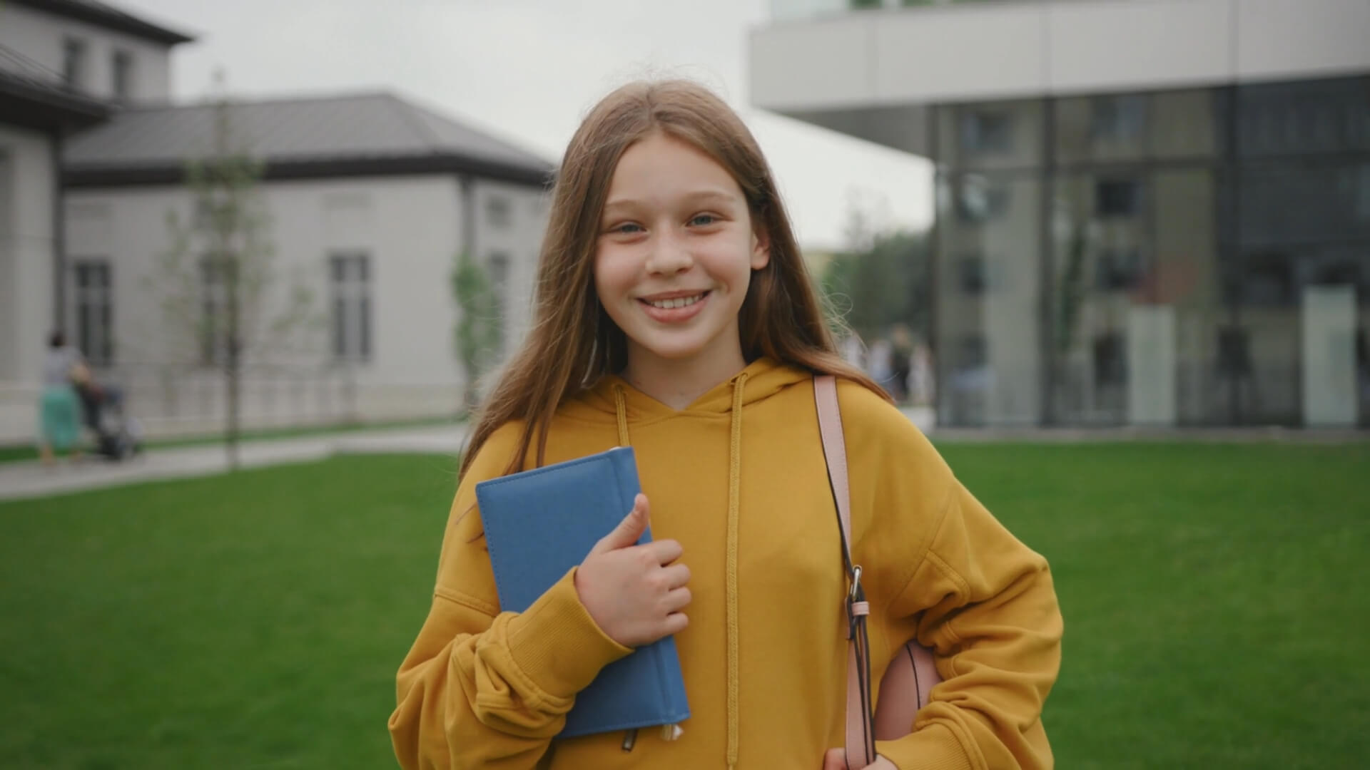 A female student holding her grades in her hand