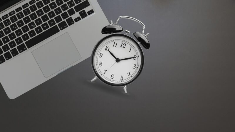 Clock and A Laptop, Symbolizing Different Work Schedules