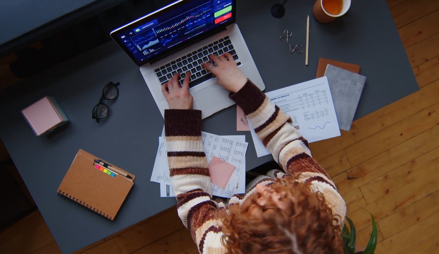 A girl student doing her online project on laptop