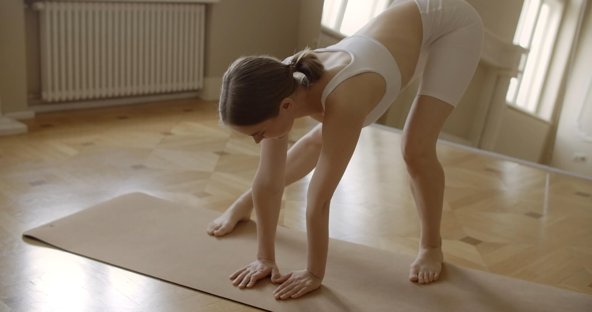 The girl bends her back and stretches before exercising