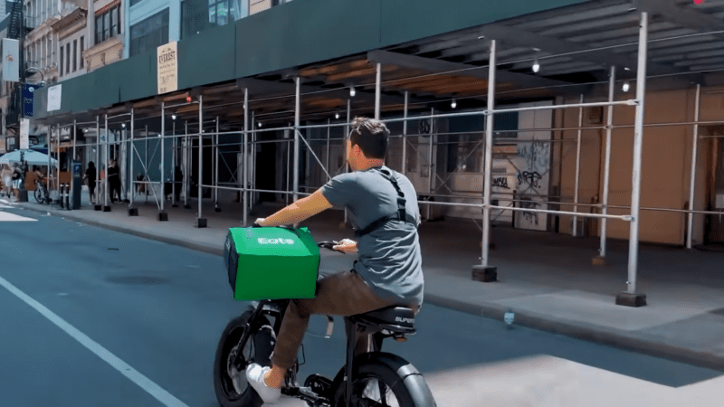 A Bike Rider with A Green Food Delivery Bag