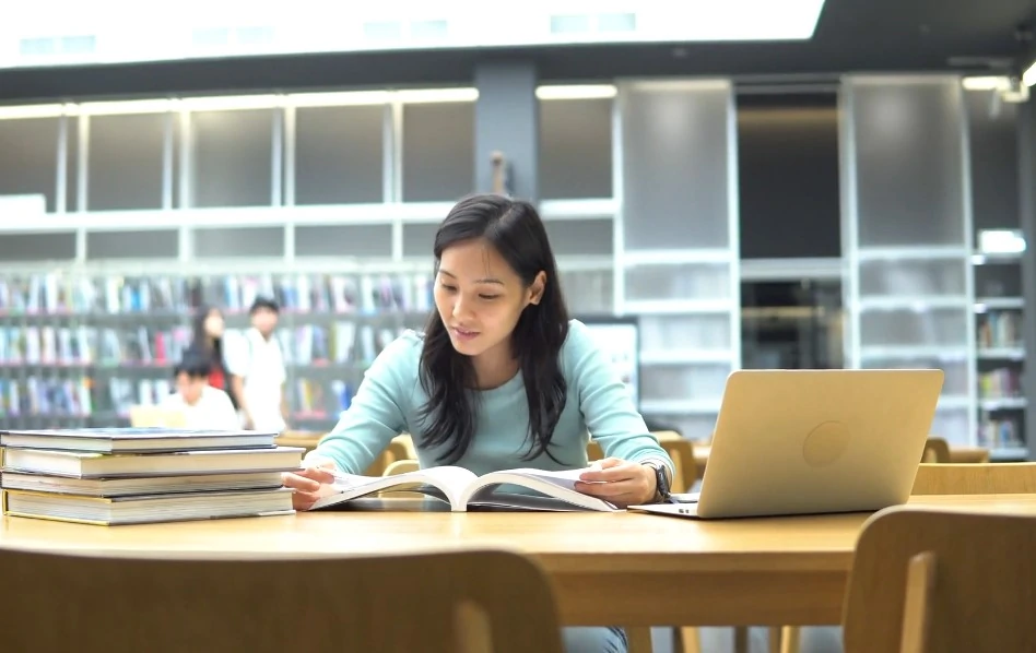 Asian girl learning in college library